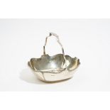 A silver cake or fruit basket, of shaped oval form, with a swingover handle, Sheffield 1923,