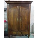 A 19th century and later French oak two door armoire with arched doors on cabriole supports,