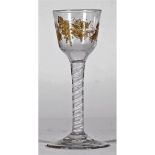 An opaque twist wine glass, circa 1765, the ogee bowl gilded, possibly later, with fruiting vine,