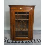 A late George III mahogany hanging corner display cabinet, 70cm wide x 98cm high.