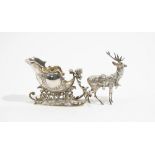 A foreign cast model of a sleigh with a reindeer, length 24cm.