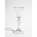 A gin glass, circa 1740, the bell bowl raised on a teared baluster stem and folded foot, 14cm. high.
