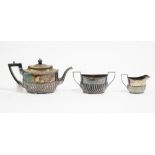 A Victorian bachelor's silver three piece tea set, Sheffield 1887, of oval form,