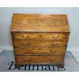A George III mahogany bureau with four long graduated drawers on bracket feet,