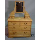 A pine dressing chest, with swing mirror over two short and two long drawers,
