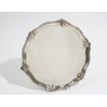 A silver salver, of shaped circular form,