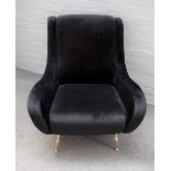 A retro design black faux suede upholstered easy armchair, on tubular lacquered brass supports,