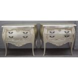 A pair of 18th century French style silver painted bombe two drawer chests, on outswept supports,