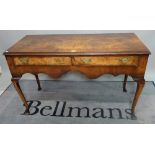 An 18th century style walnut two drawer lowboy, on cabriole supports, 121cm wide.