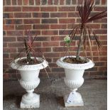 A pair of white painted cast iron garden jardinieres, with egg and dart rims and semi-fluted bodies,