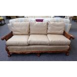 An early 20th century carved walnut framed double bergere three piece suite, to comprise sofa,