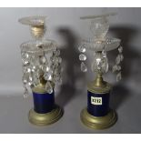 A pair of early 20th century brass and glass candlesticks, 32cm high, (2).