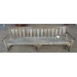 A modern hardwood garden bench, 243cm wide 87cm high.