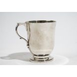 A silver christening mug of inverted bell shaped form, the handle having a flat thumbpiece,