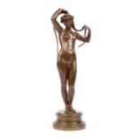 A 19th century bronze figured nude modelled with a lady plaiting her hair, unsigned,