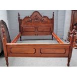 A contemporary carved mahogany rosewood banded double bed, in period style, with arched headboard,