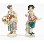 A pair of Meissen figures of gardeners, 20th century, modelled as a youth holding a posy of flowers,