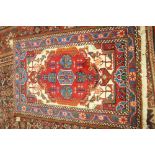 A Hamadan rug, Persian, the ivory held with a large madder medallion,