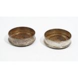 A pair of silver mounted circular bottle coasters, having turned wooden bases, London 1977,