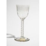 An engraved wine glass, circa 1760, the moulded ogee bowl engraved with fruiting vine,