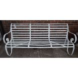 A 19th century white painted strap iron garden bench, 183cm wide x 82cm high.