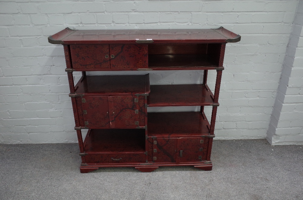 An early 20th century Japanese scarlet lacquered metal mounted side cabinet,