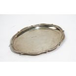 A silver dressing table tray of shaped oval form, having a reeded rim, London 1918, length 27cm,