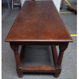 A 17th century style teak refectory table, the rectangular top on eight turned supports,