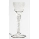 An engraved opaque twist wine glass, circa 1765, the ogee bowl engraved with flowers,