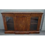 A Victorian figured walnut breakfront three door side cabinet on plinth base,