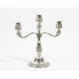 A foreign three branch table candelabra, with floral and foliate decoration,