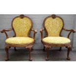 After Alexander Peter, a pair of George II style gilt framed open armchairs, 85cm wide x 109cm high.