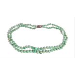 A two row necklace of jade beads, graduating in the size to the front,