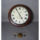 A 19th century mahogany circular wall clock, 40cm wide, with one pendulum and two keys.