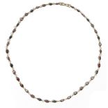 A precious yellow metal and coloured spinel-set necklace, of graduated design,