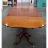 A Regency style mahogany triple pillar extending dining table,