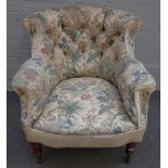 A late 19th / early 20th century tub back easy armchair, on turned mahogany supports,