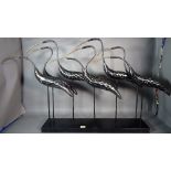 A modern metal sculpture of eight Egrets, 70cm wide x 61cm high.