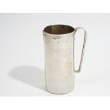 An Italian jug, of cylindrical form with an applied handle, the body with martele decoration,