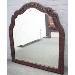 A 19th century Eastern hardwood arch top mirror, with foliate chased frame, 112cm wide x 123cm high.