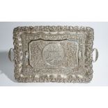 An Asian shaped rectangular twin handled tray, the central reserve decorated with elephants bathing,