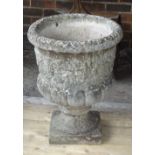 A reconstituted stone jardiniere, with floral moulded body and turned socle,