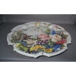 A large modern tile glaze ceramic wall plate painted with bird of prey and flowers, 57cm wide.