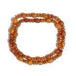 A single row necklace of varicoloured, butterscotch coloured amber beads, of varying size,