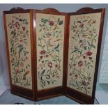 A modern stained beech framed three fold arch screen, decorated with birds of paradise,