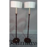 A pair of 20th century stained beech barley-twist standard lamps,