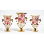 A garniture of three English porcelain campana shaped two-handled vases, circa 1830,