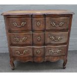 An 18th century style Continental oak chest with three long serpentine drawers, on scroll feet,