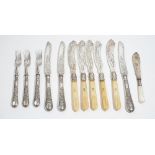 Five Victorian silver bladed fish knives, having engraved decoration and with carved ivory handles,