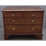 A mid-18th century oak chest, of two short and two long graduated drawers on bracket feet,